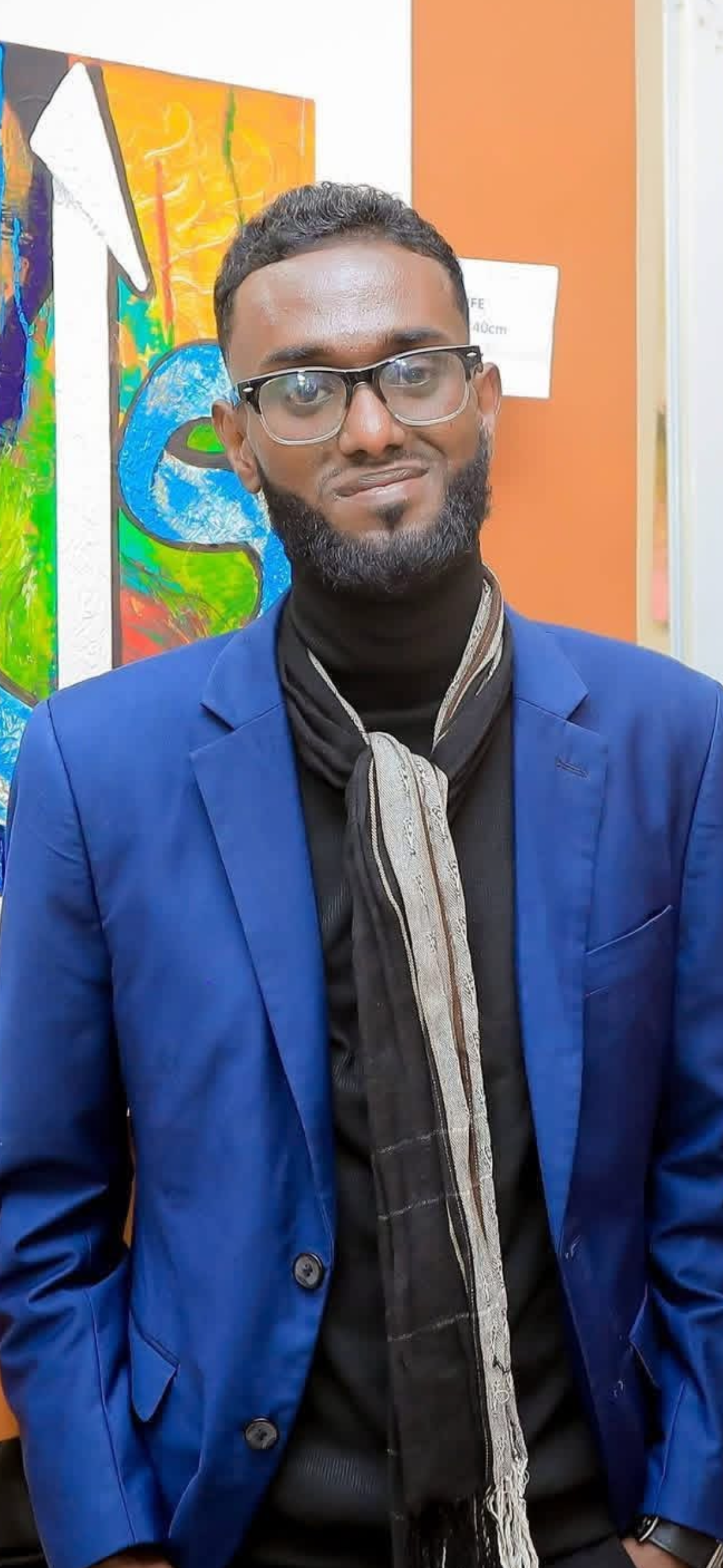 Dek Ahmed Moussa Gaffaneh, peintre djiboutien, devant ses œuvres